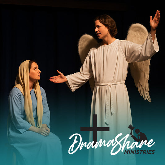  A theatrical stage scene depicts the biblical Annunciation with Mary seated in a blue robe and beige headscarf, looking up at Angel Gabriel