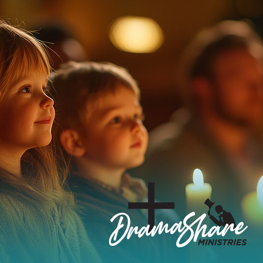 Two children sitting together with a candle in the background.