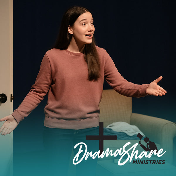  Young woman performing a monologue in a bedroom set, gesturing toward an unseen guest at the door; a cozy chair, lamp, Bible, and laundry are visible behind her.