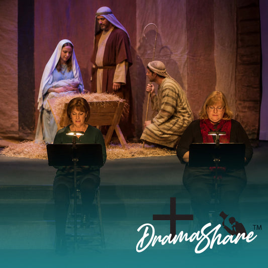Stage set with nativity scene and actors using laptops, featuring DramaShine logo.